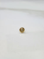Close up of round textured gold nose pin design on white background elegant and refined for women