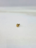 Front view of a small gold nose pin on a white background displaying its compact design