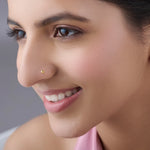 Woman wearing a minimalist gold nose pin showcasing an elegant everyday look