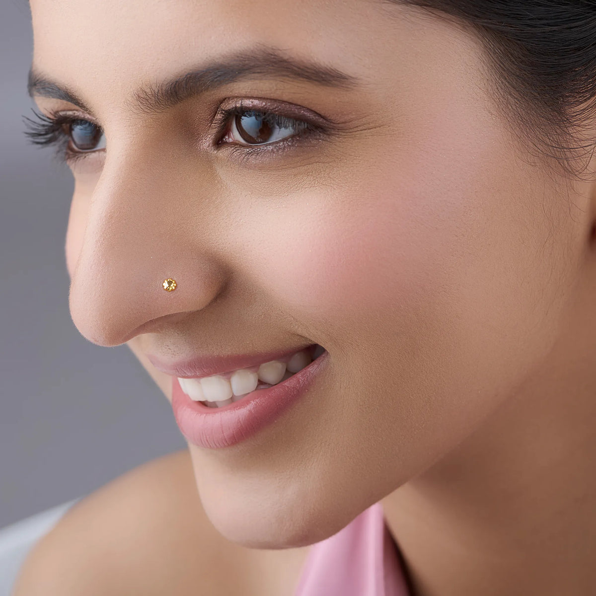 Woman wearing a minimalist gold nose pin showcasing an elegant everyday look