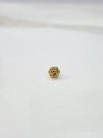 Close-up of tiny 18K Nose Pin Gold on marble surface displaying delicate detailing