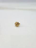 Small 18K Nose Pin Gold placed on a white surface showing fine craftsmanship