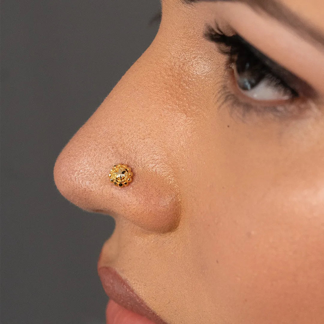 Woman wearing a delicate 18K nose pin gold showcasing an elegant and minimal everyday look