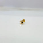 Small floral 18K nose pin gold placed on a white background showing fine detailing