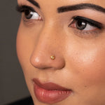 Woman wearing a delicate 18K nose pin gold showcasing an elegant everyday ethnic look
