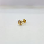 Side view of tiny 18K nose pin gold captured on a white surface highlighting its polished finish