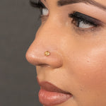 Model view of woman wearing a delicate 18K nose pin gold showcasing a minimal and elegant everyday look