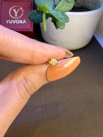 Hand view of tiny 18K nose pin gold near a Yuvora box showing its small wearable size