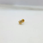 Close-up view of star motif 18K nose pin gold on a white surface displaying its fine detailing