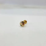 Side view of multicolour stone 18K nose pin gold placed on a white surface showing its polished finish