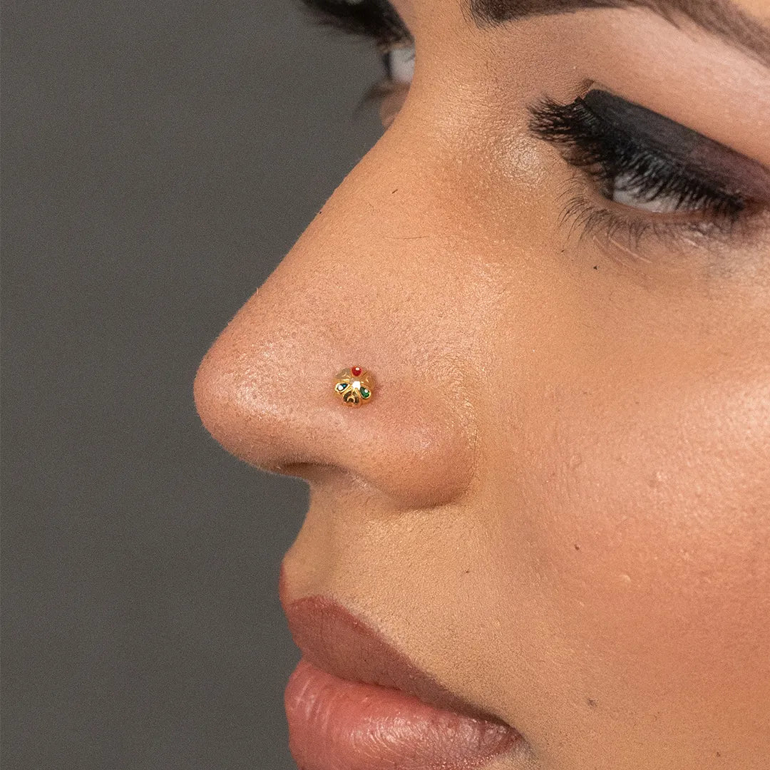 Side profile view of woman wearing 18K nose pin gold showing its small multicolour stone design