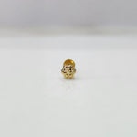 Side view of tiny floral 18K nose pin gold on a white surface highlighting its smooth finish