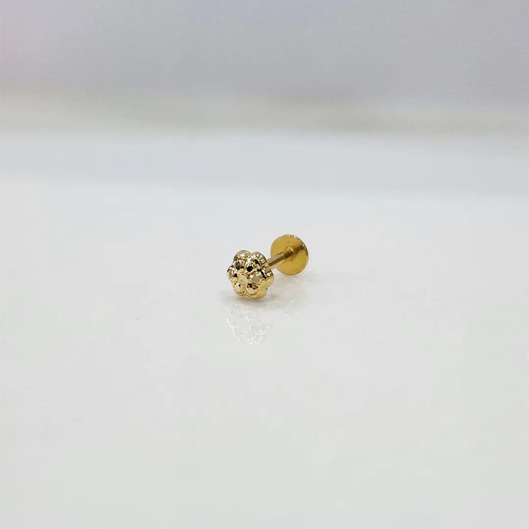 Front view of small floral 18K nose pin gold placed on a white background showing intricate detailing