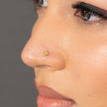 Woman wearing a delicate 18K nose pin gold showcasing a minimal and elegant everyday look