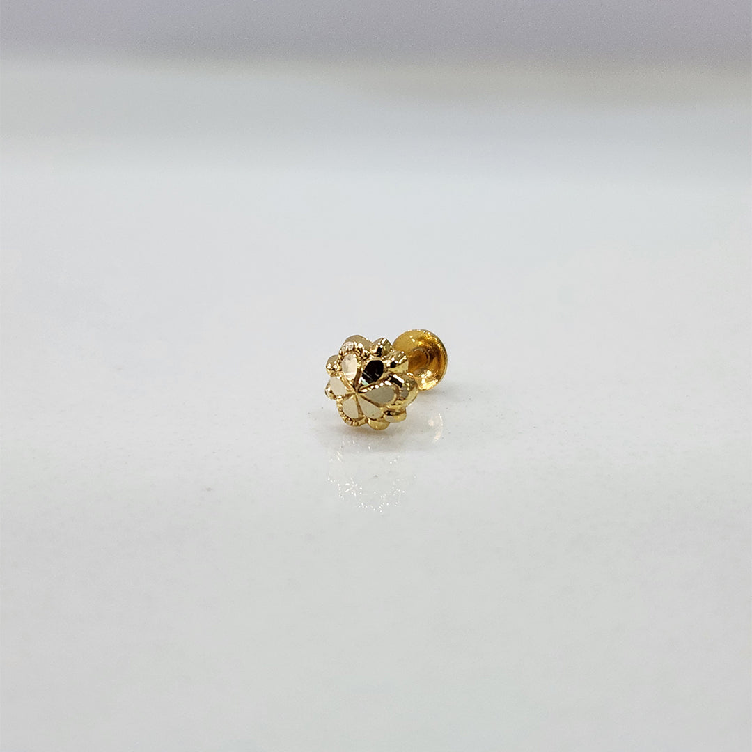 Front view of tiny floral 18K nose pin gold on a white background showing fine craftsmanship