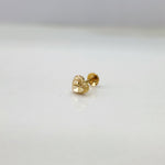 Side view of heart motif 18K nose pin gold placed on a white surface displaying its polished finish