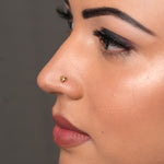 Woman wearing a minimalist 18K nose pin gold showcasing an elegant everyday heart design