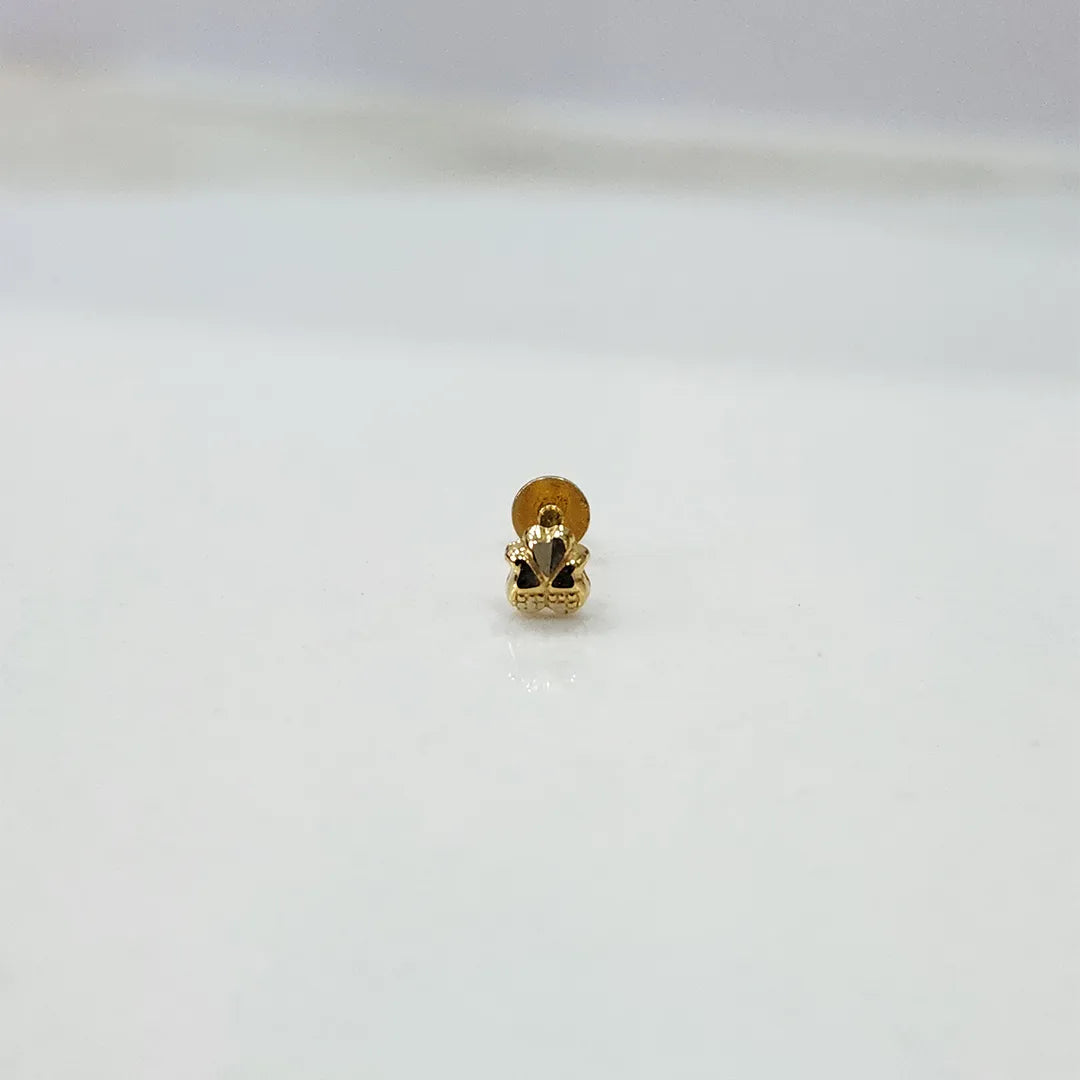 Small 18K nose pin gold displayed on a white surface capturing its fine floral detailing