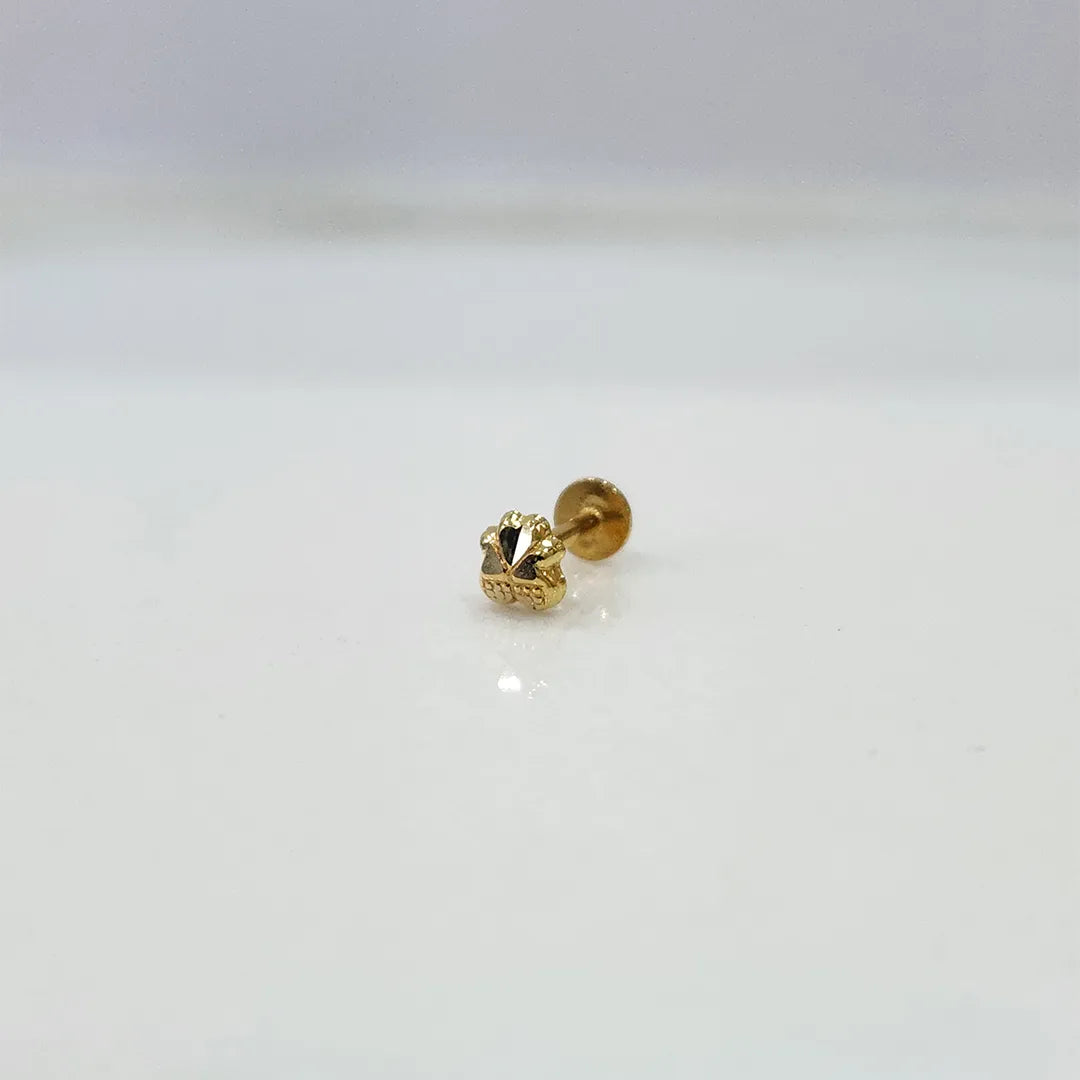 Tiny floral 18K nose pin gold placed on a clean white background showing its intricate craftsmanship