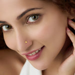 Woman wearing a delicate 18K nose pin gold showcasing an elegant and minimal everyday look