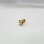 Small floral 18K nose pin gold displayed on a white surface capturing its fine textured design
