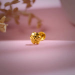 Floral cluster 18K nose pin gold placed on a soft pink backdrop highlighting its intricate handcrafted detailing