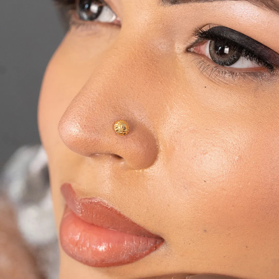 Woman wearing round 18K nose pin gold showcasing a simple and elegant everyday look
