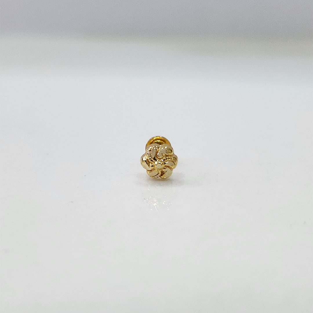 Tiny floral 18K nose pin gold displayed on a clean white surface showing its fine handcrafted work