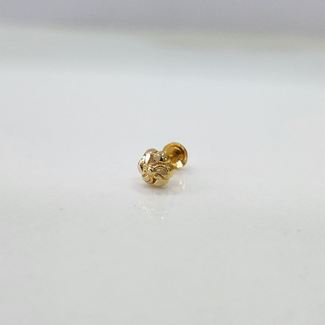 Small floral 18K nose pin gold on a white background capturing its intricate miniature design