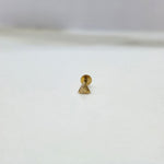 Tiny triangle 18K nose pin gold photographed on a white background showing fine geometric detailing