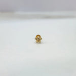 Tiny floral 18K nose pin gold displayed on white background showing intricate petal detailing