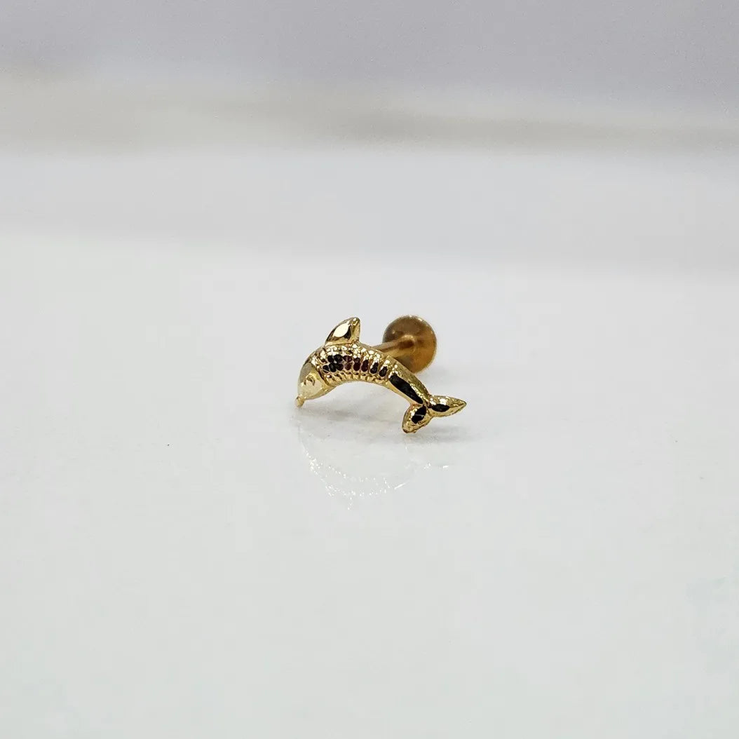 Small dolphin motif 18K nose pin gold placed on a white surface showcasing delicate craftsmanship
