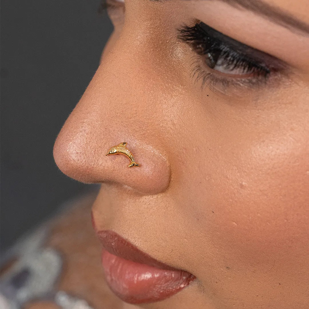 Woman wearing dolphin design 18K nose pin gold highlighting a minimal elegant look