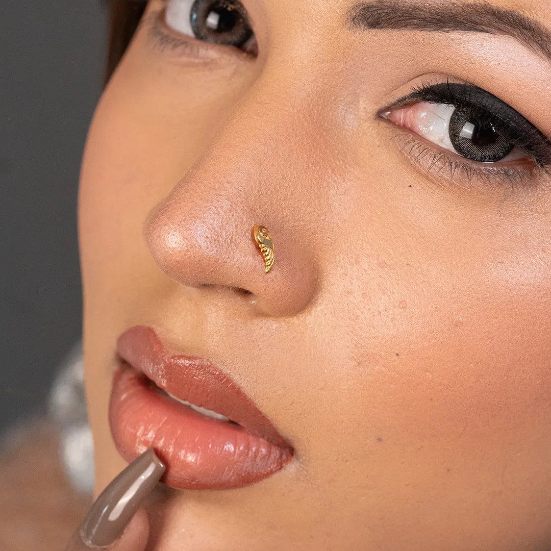 Woman wearing a delicate 18K nose pin gold showcasing an elegant everyday look
