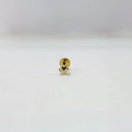 Close-up of a small gold star nose pin placed on a white background for clarity