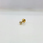 Tiny gold star nose pin on a white surface showing delicate detailing