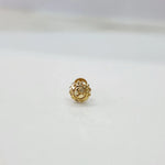 Close-up of tiny gold nose pin placed on a white background for clarity