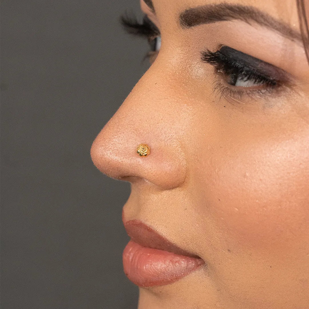 Woman wearing a tiny gold nose pin styled for a simple elegant look