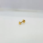 Side view of delicate 18K nose pin gold placed on a white surface reflecting its subtle shine