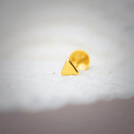 Minimal triangle gold nose pin design crafted in 18k yellow gold with smooth polished finish on white background