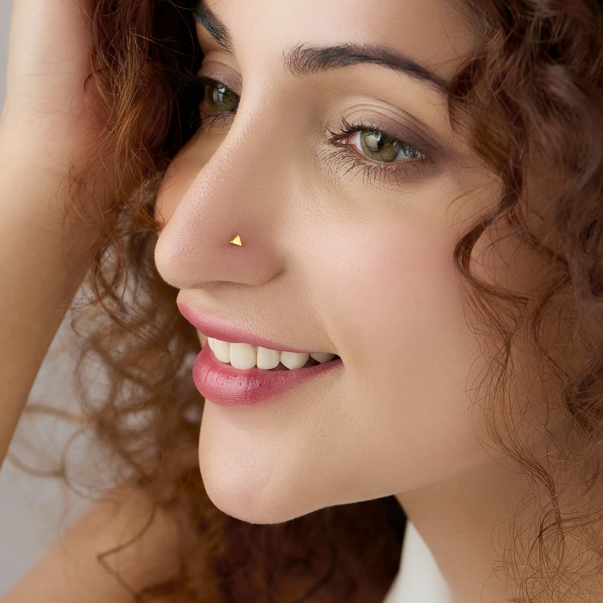 Woman wearing triangle gold nose pin showcasing modern minimalistic everyday style