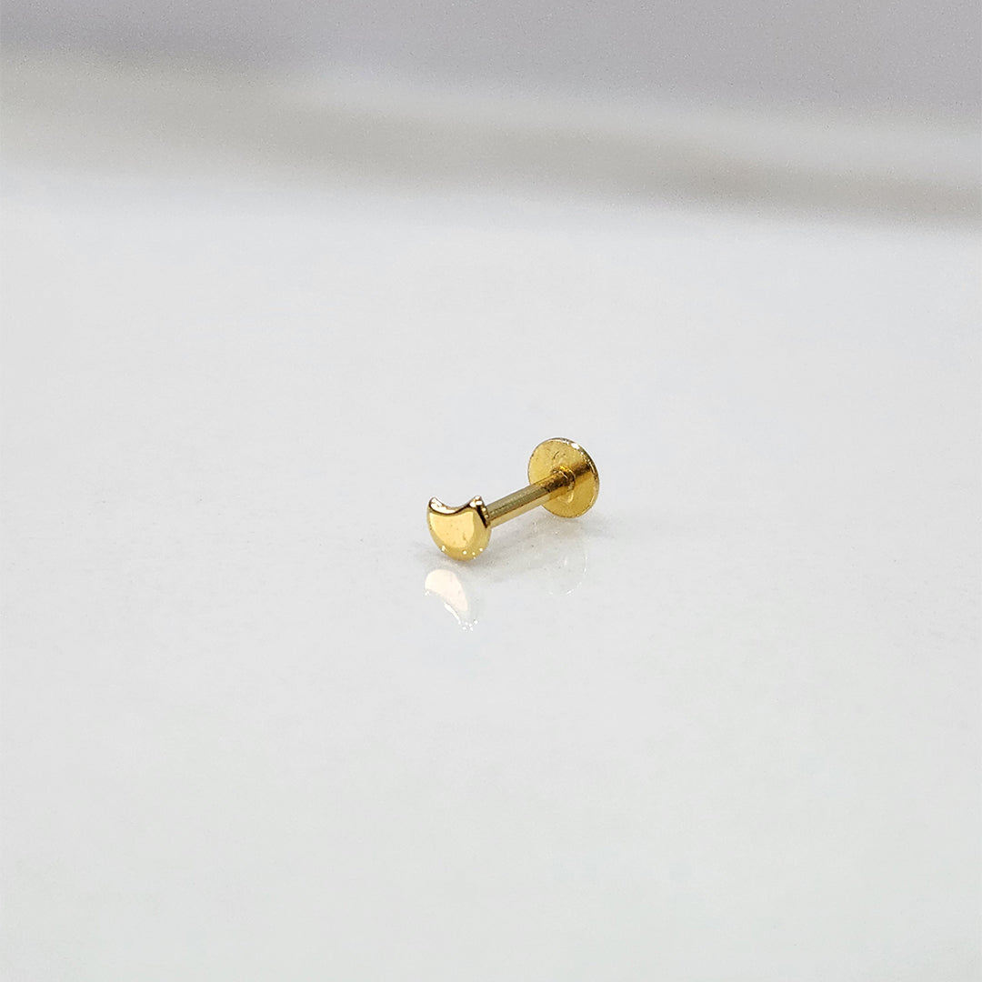 Tiny 18K nose pin gold captured on a marble-like surface highlighting its subtle shine