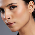 Model wearing a sleek 18K gold nose ring showcasing refined everyday elegance on the face