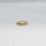 Top view of small twisted design gold nose ring placed on a clean white surface highlighting detailing