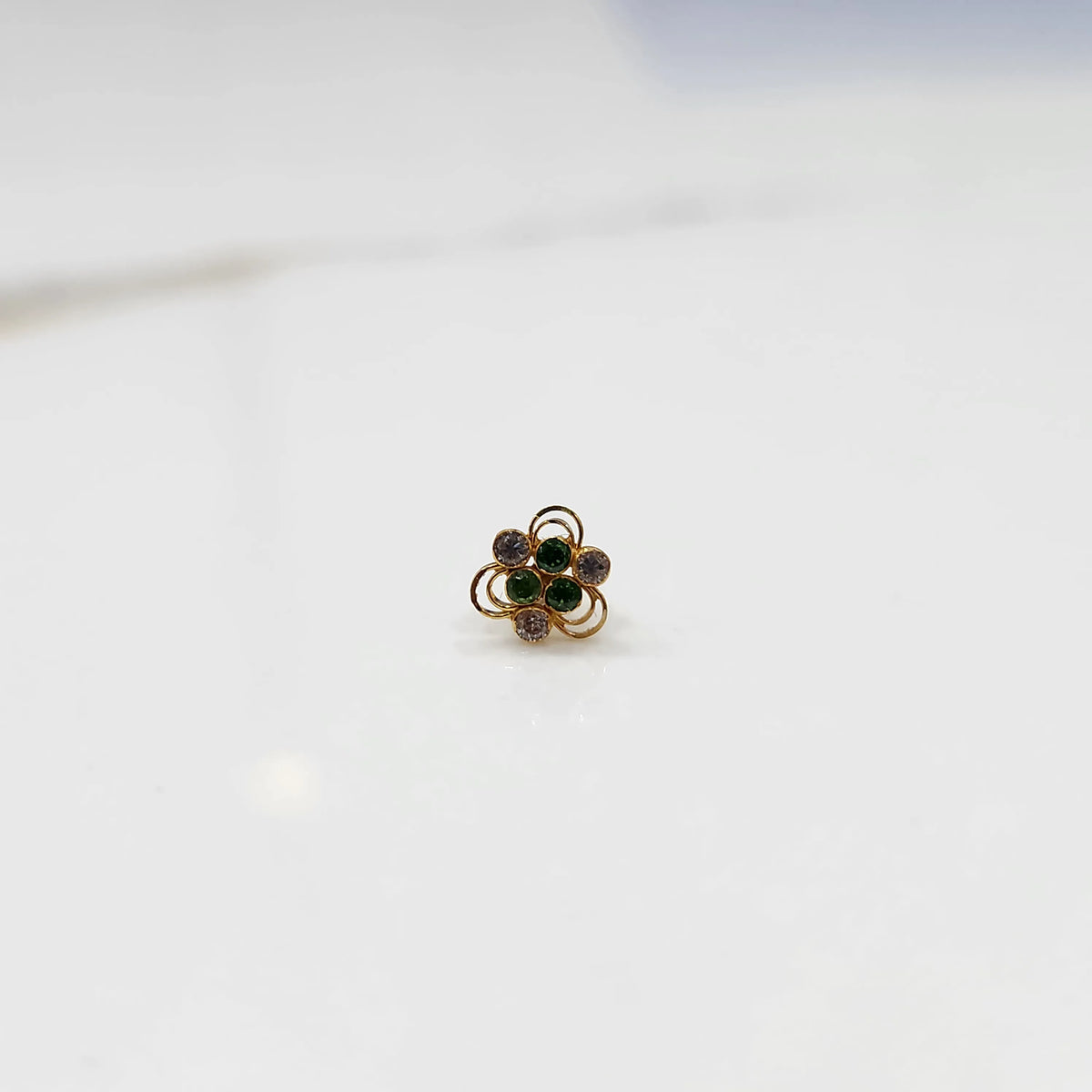 Alternate front angle of the floral stone nose pin displaying balanced stone placement