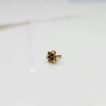 Distant view of the stone gold nose pin on a white background showing its petite everyday size