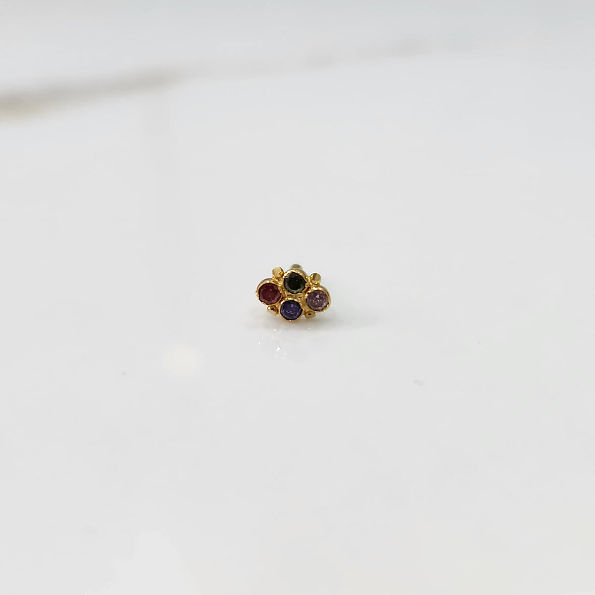 Women's gold nose pin design with compact flower design