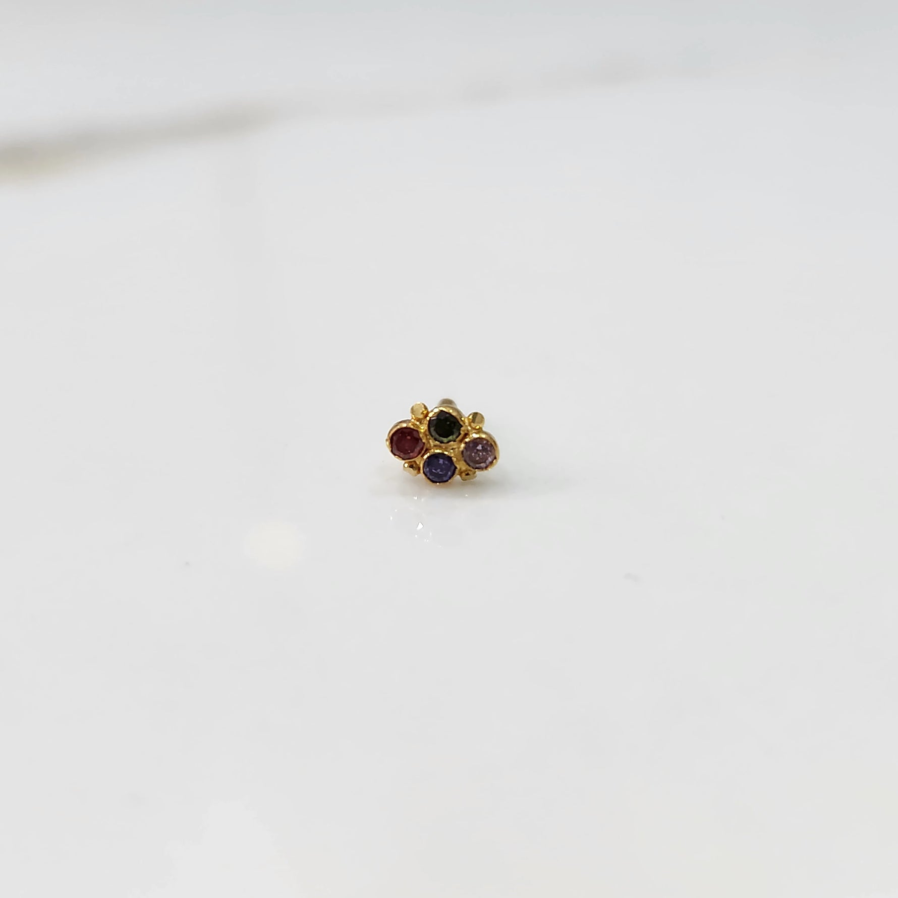 Women's gold nose pin design with compact flower design