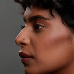 Woman wearing tiny 18k gold nose pin showcasing elegant minimalist ethnic look