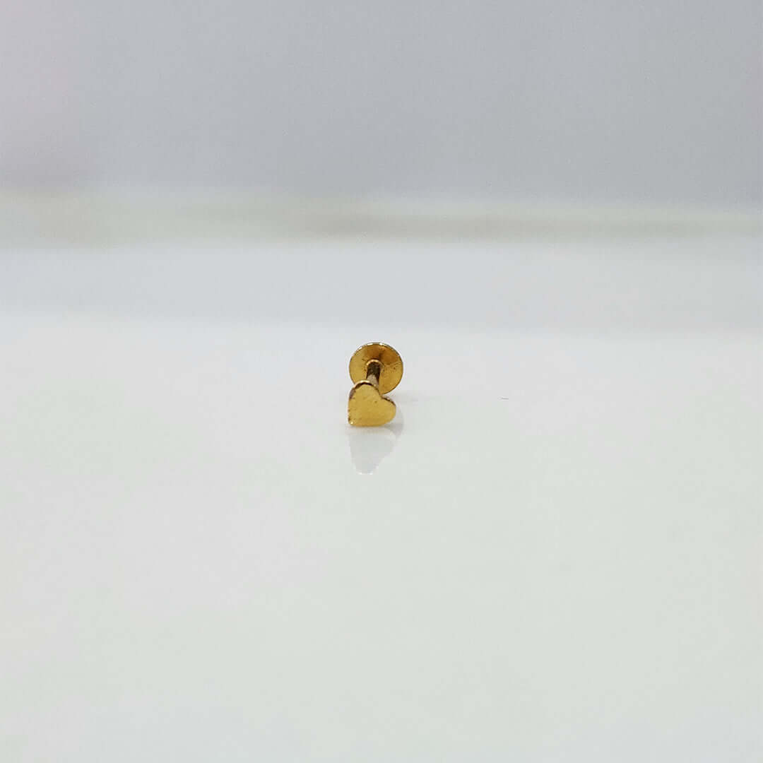 Front view of small heart 18K nose pin gold on a white background showing fine detailing